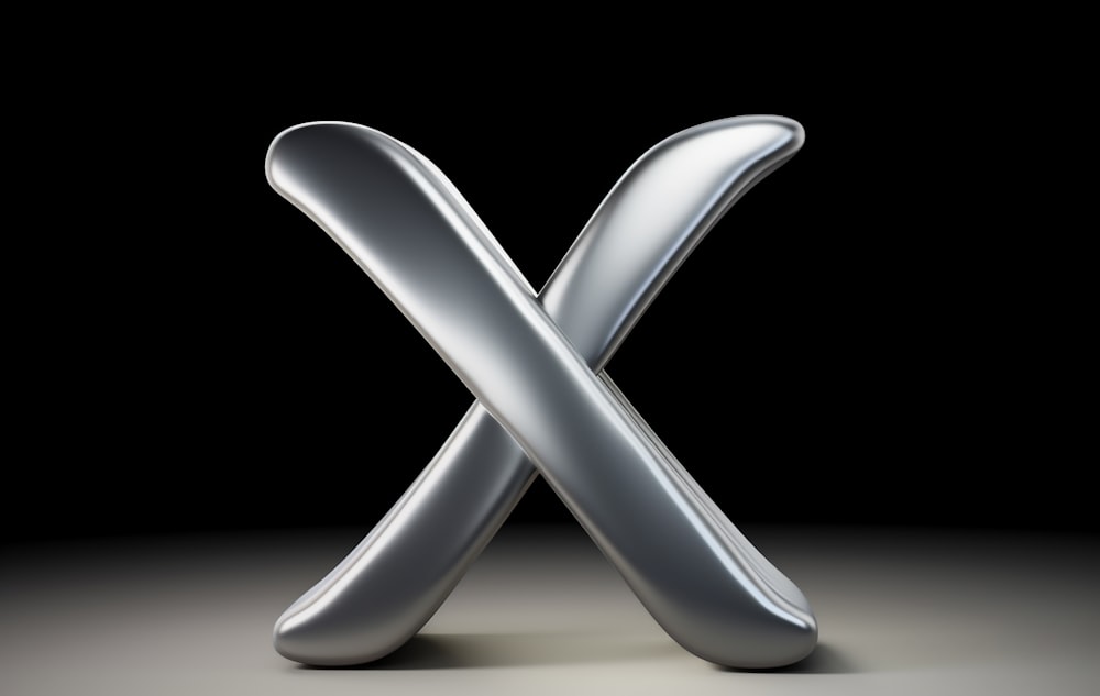 a silver letter x on a black background