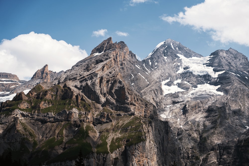 a mountain range with snow capped mountains in the background