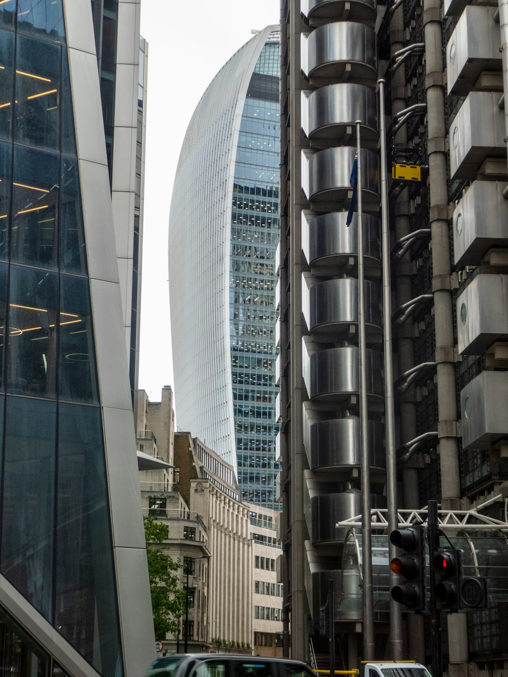 a car driving down a street next to tall buildings