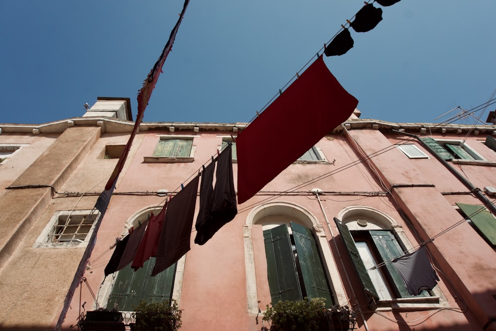 a building with green shutters and a red sign