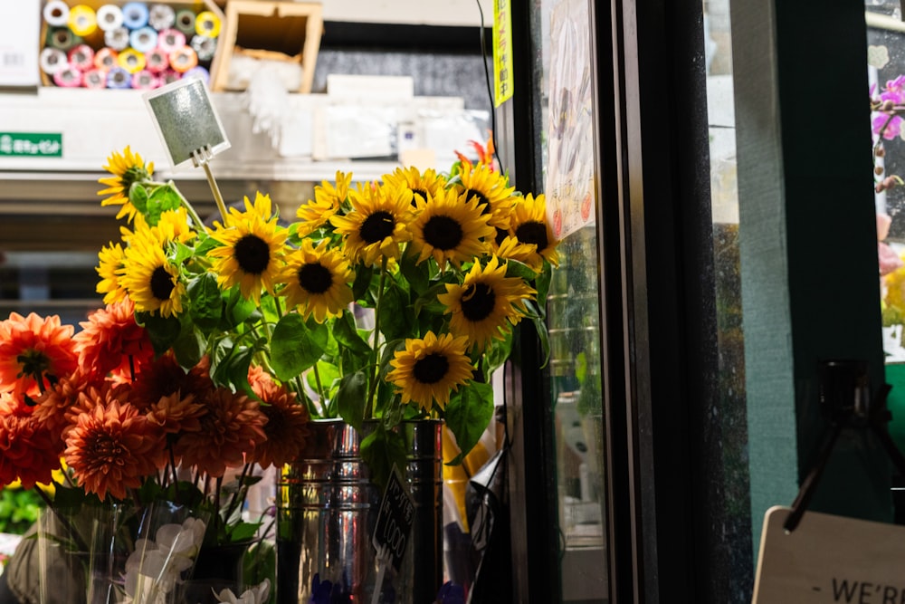 a bunch of sunflowers in a vase on a window sill