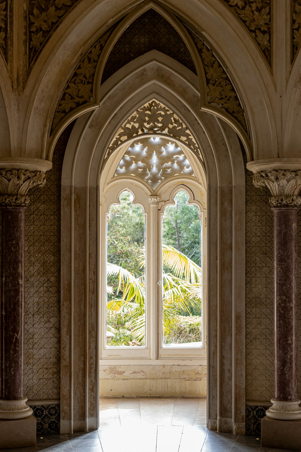 a large arched window in a stone building