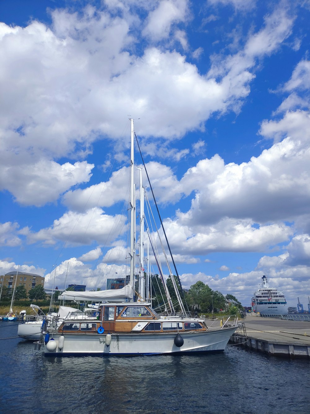 a sailboat docked at a dock in a harbor