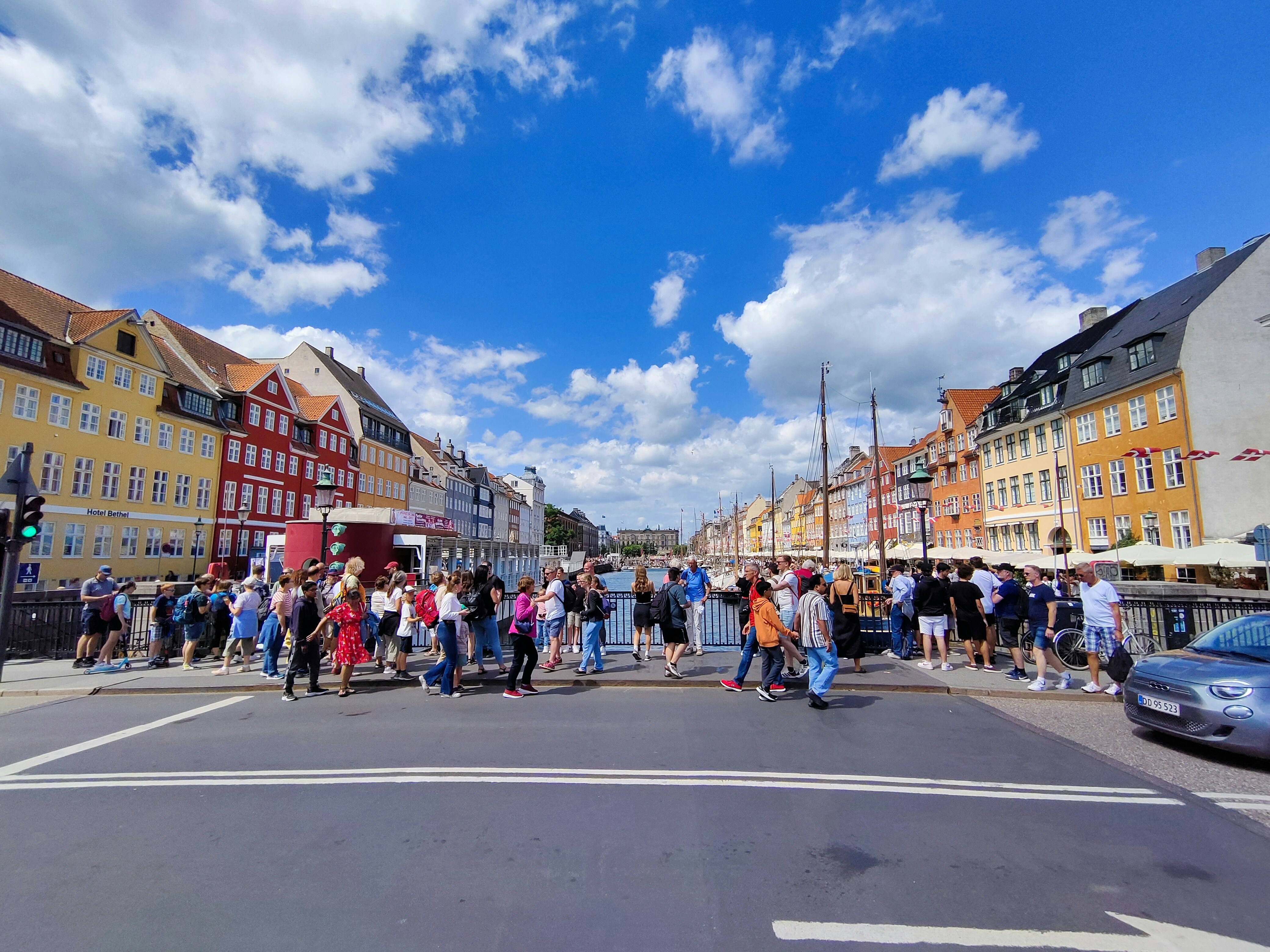 a group of people standing on the side of a road