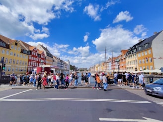 a group of people standing on the side of a road
