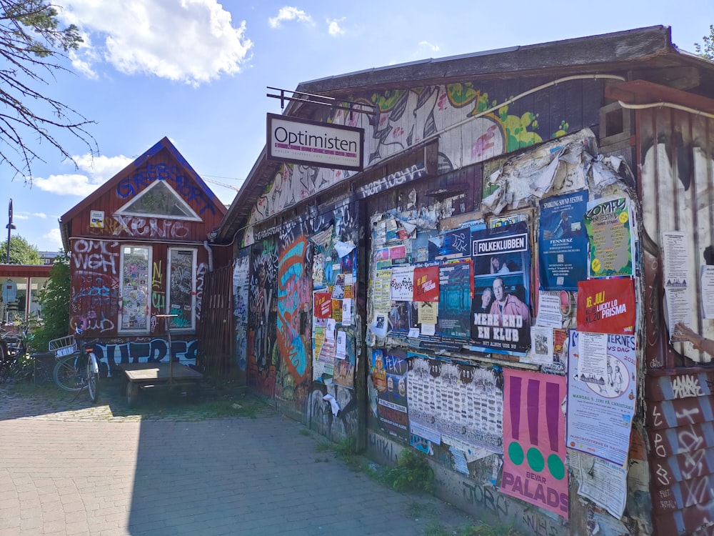 a building with a bunch of posters on the side of it