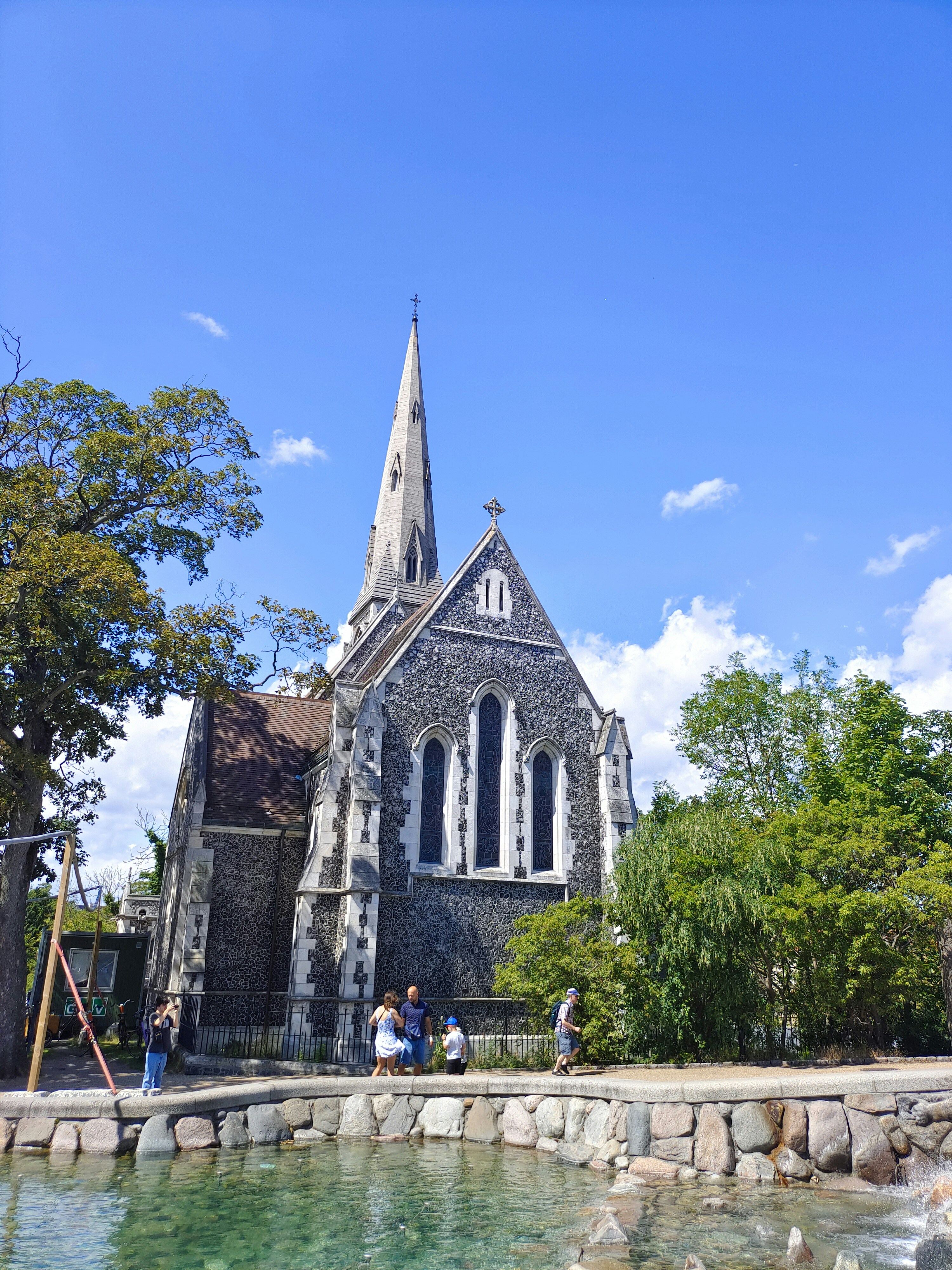 a church with a pond in front of it