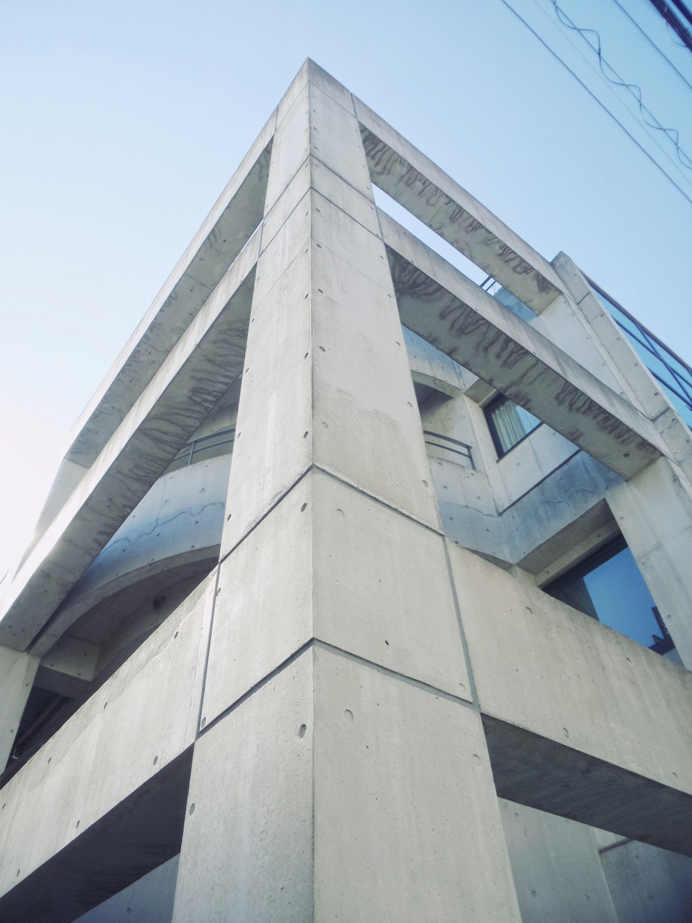 a tall concrete building with a sky background