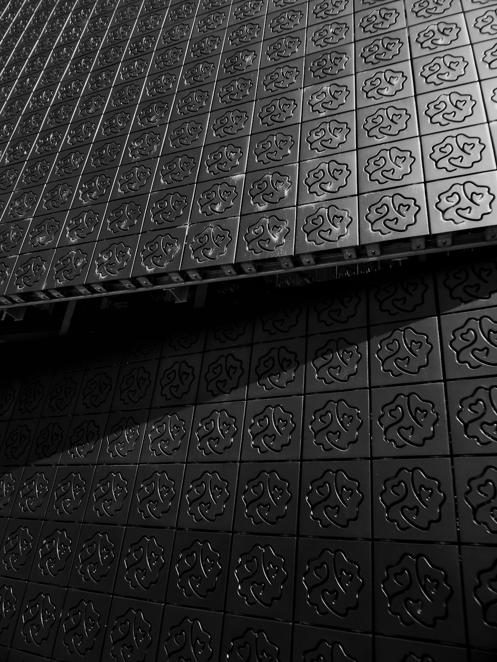 a black and white photo of a tiled floor