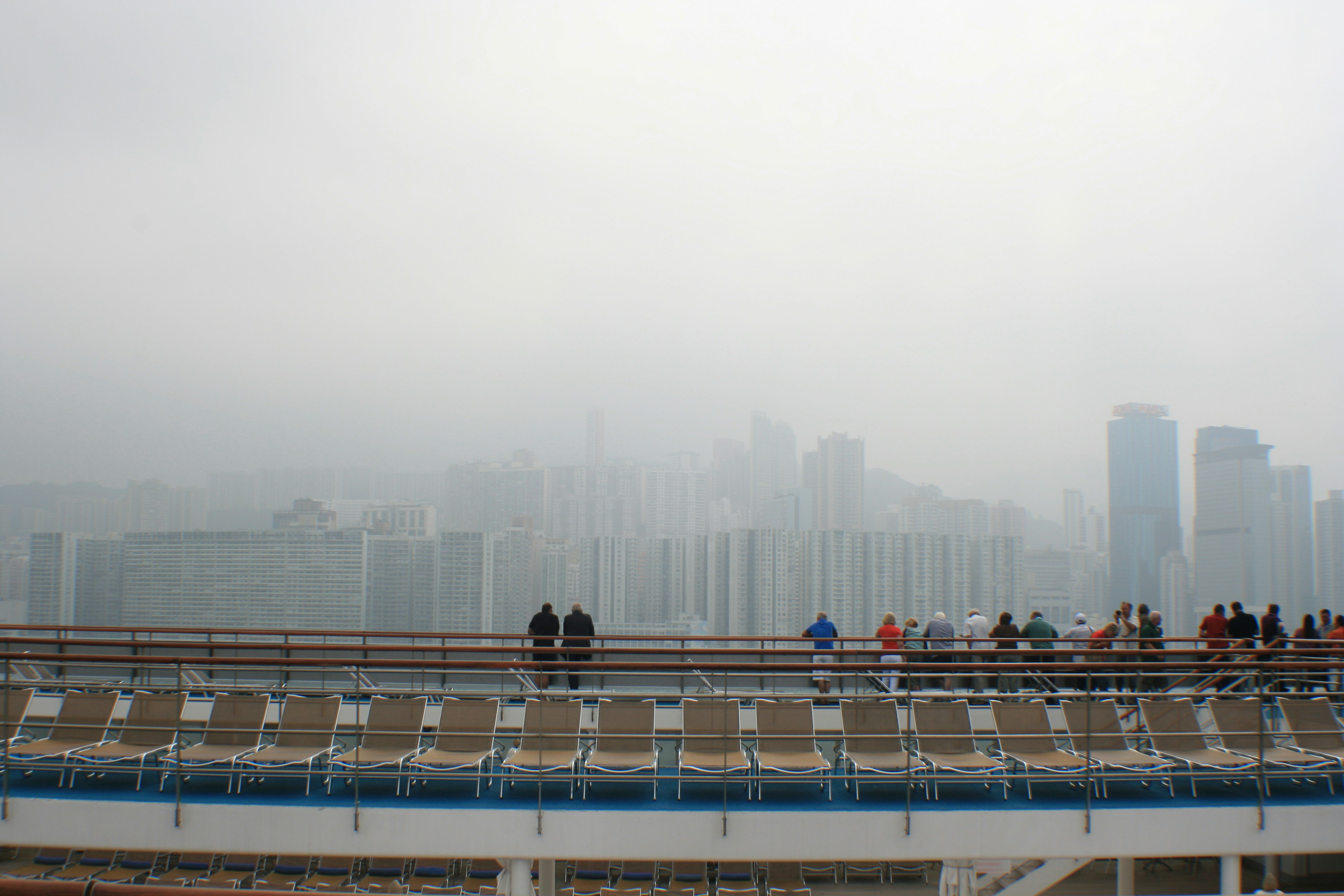 a group of people standing on top of a bridge