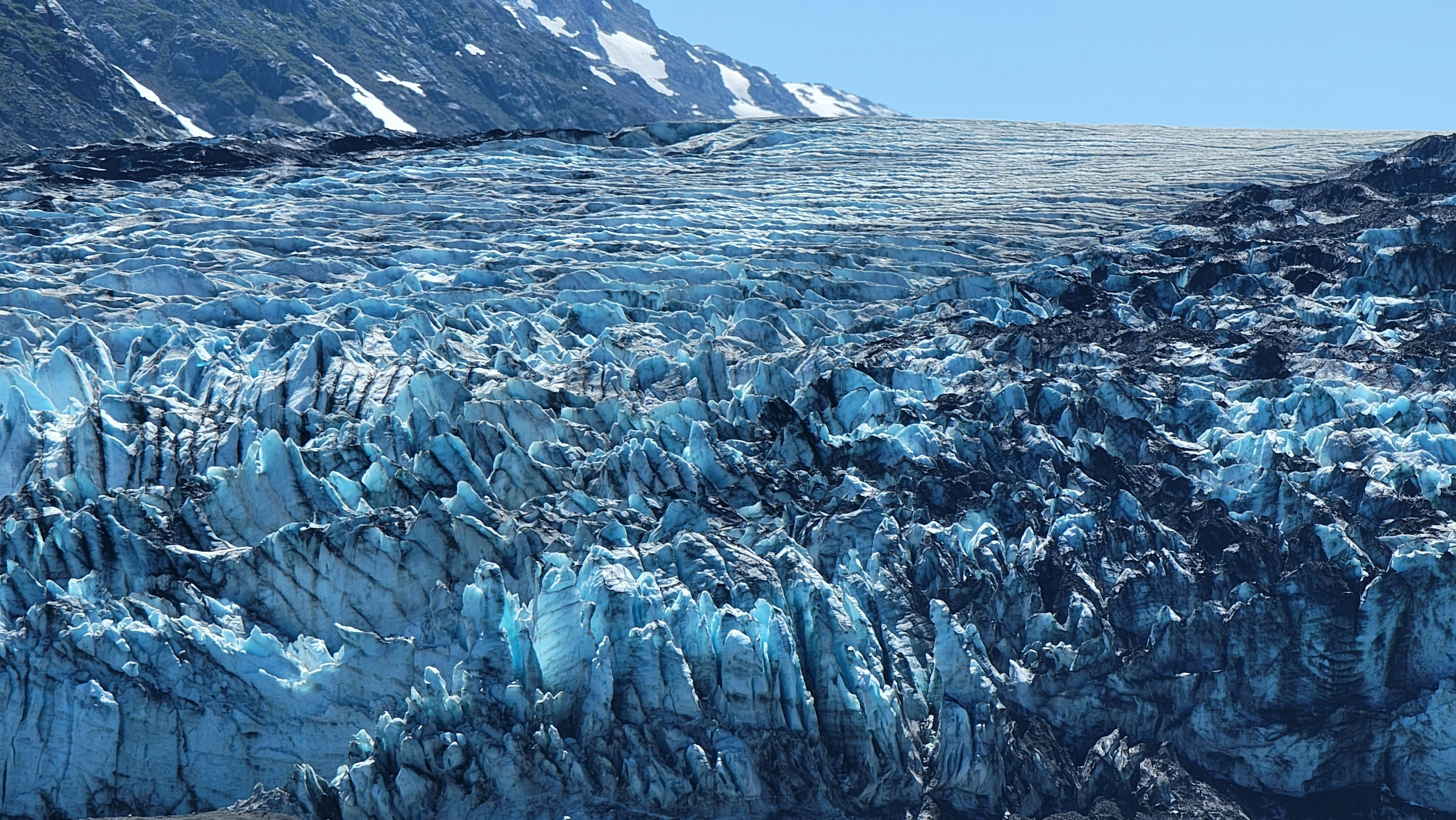 a large glacier with lots of blue ice, 