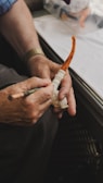 Artisan carefully shaping a custom leadpipe in a warm, softly lit workshop.
