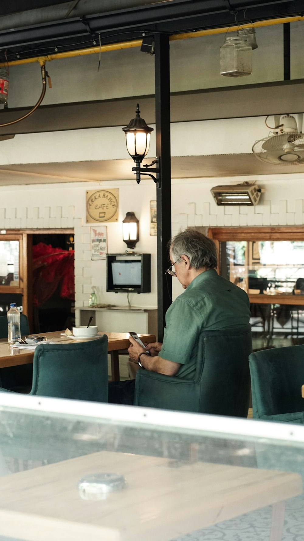 a man sitting at a table using a cell phone