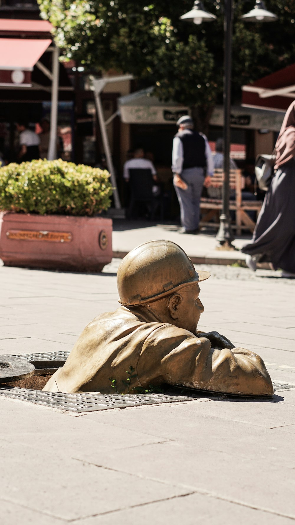 a statue of a man laying on the ground