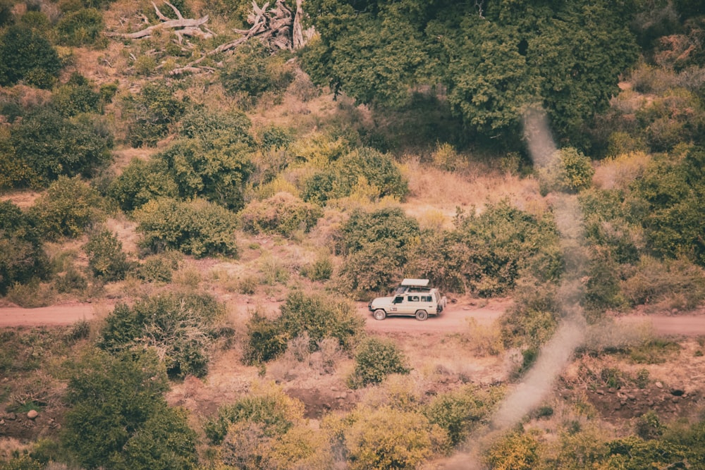 a van is parked in the middle of a dirt road