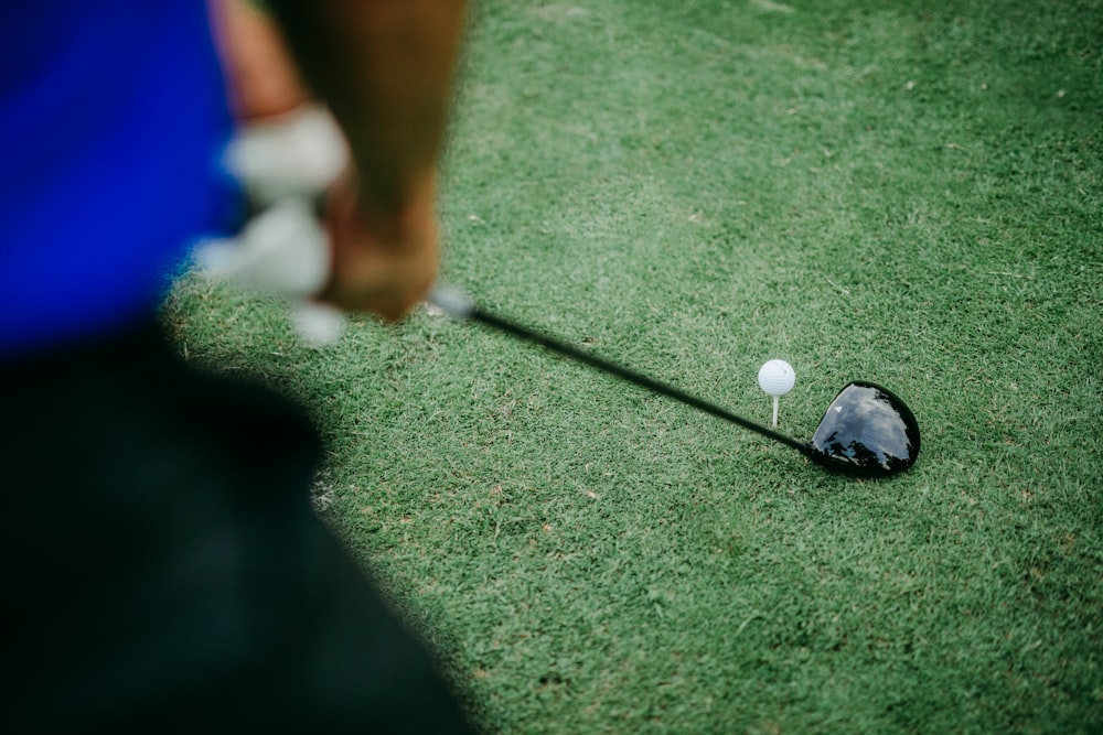 a golf ball on the ground with a driver