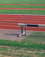 A finished athletic track with athletes training.