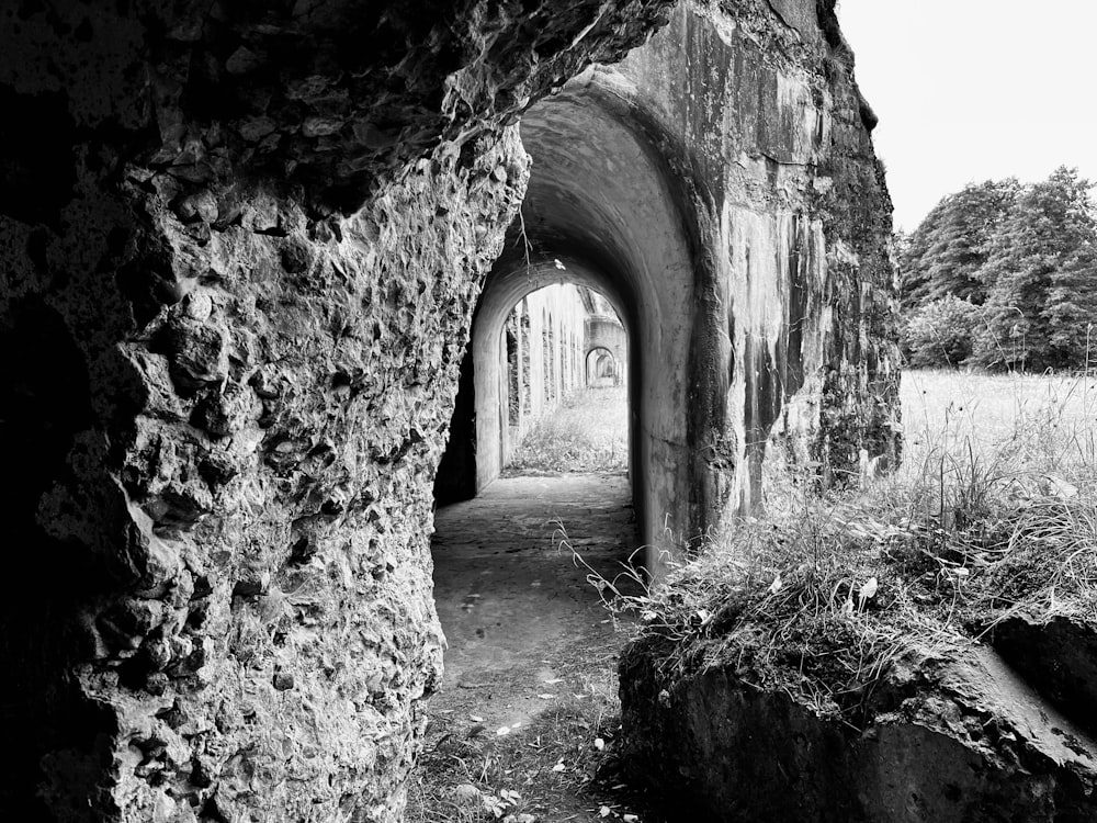 a black and white photo of a stone tunnel