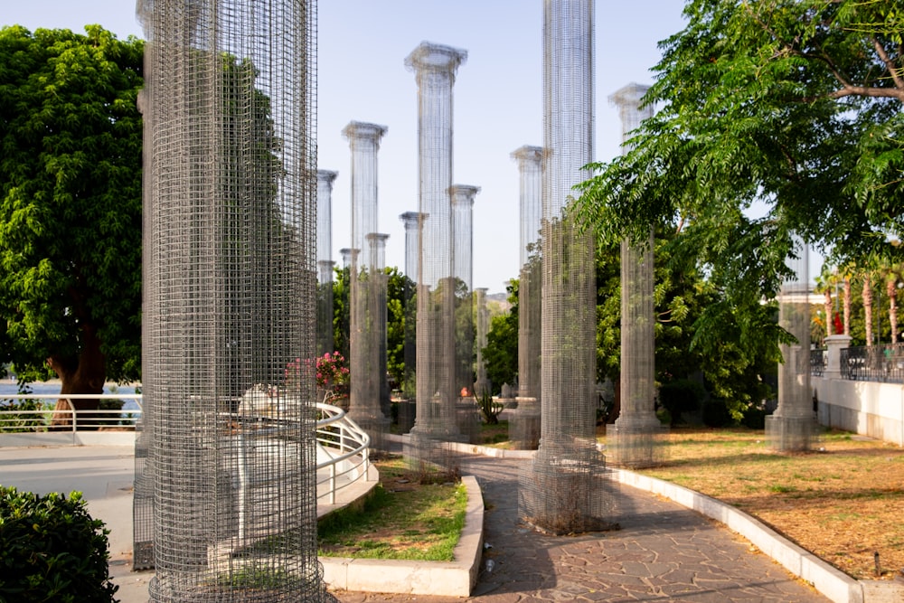 a bunch of tall metal poles in a park