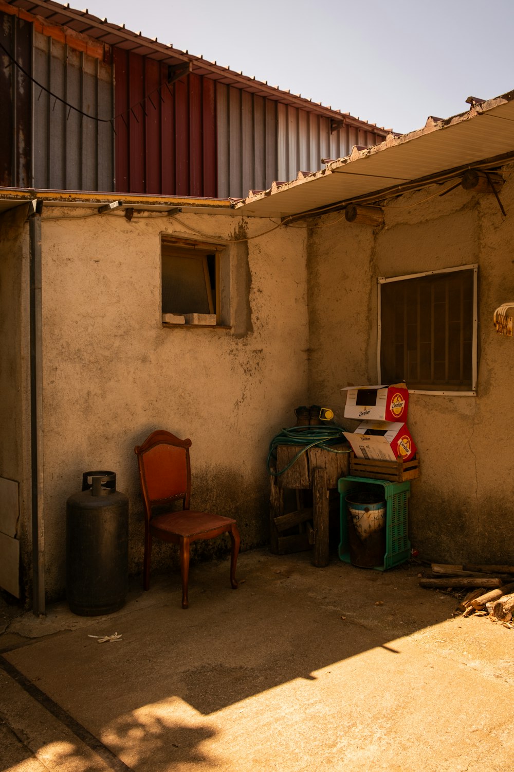 a room with a chair, a table and a trash can