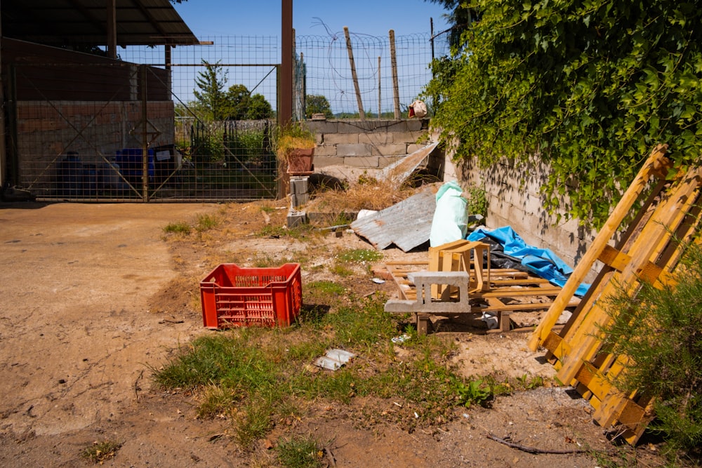 a pile of junk sitting next to a fence