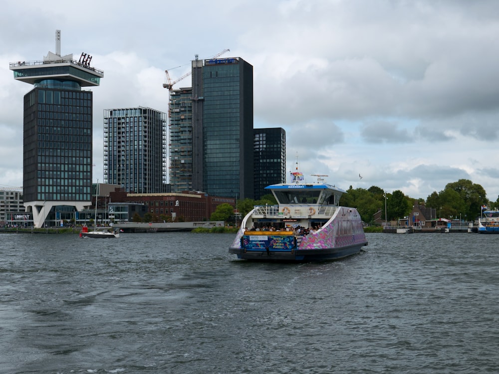 a boat in a body of water with a city in the background