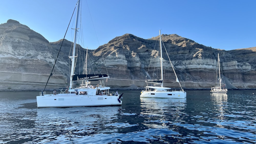 a couple of boats floating on top of a body of water