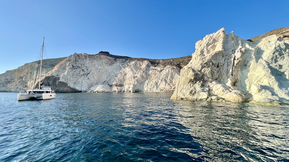 a white boat floating on top of a body of water