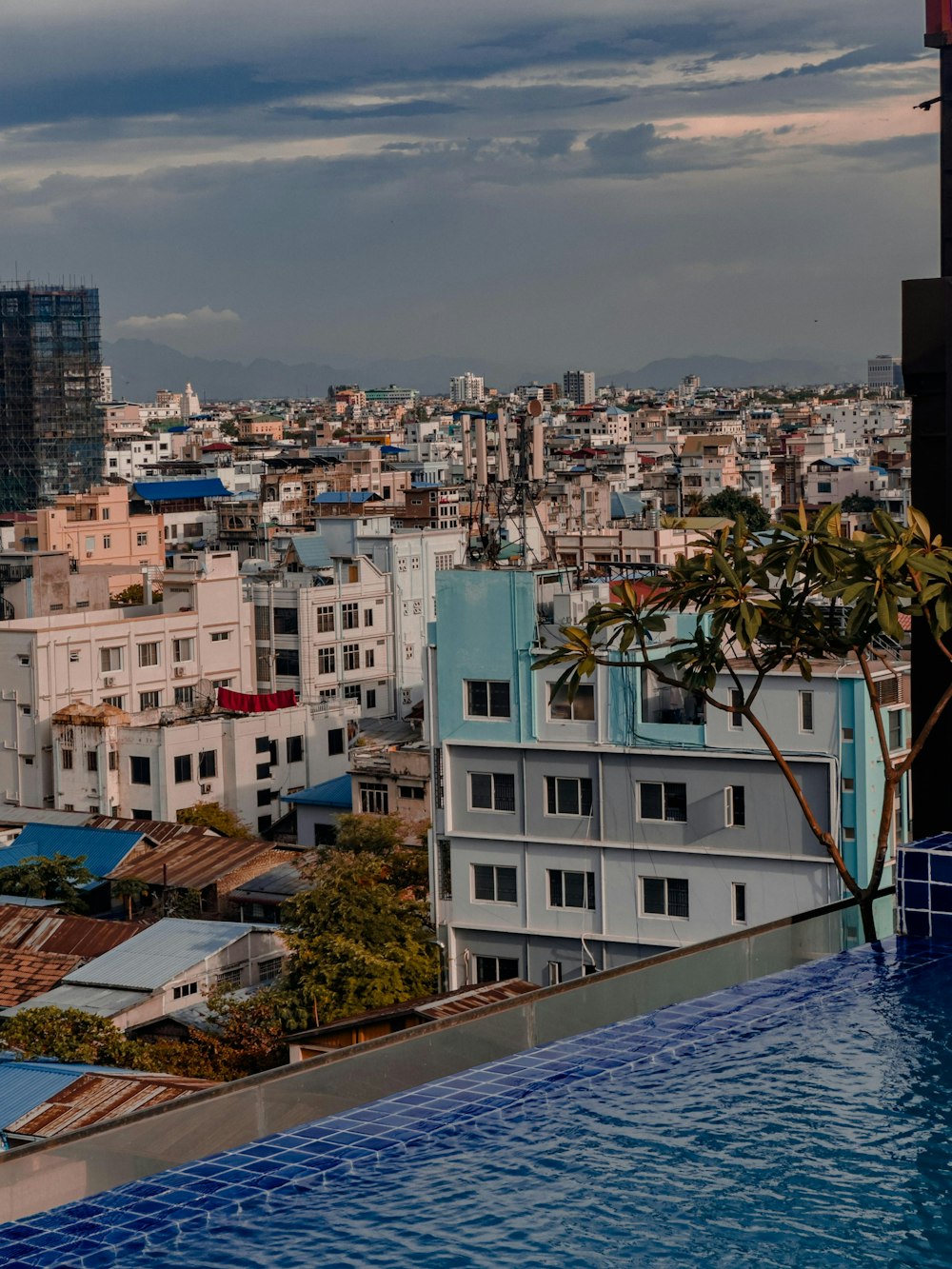 a view of a city from a rooftop pool