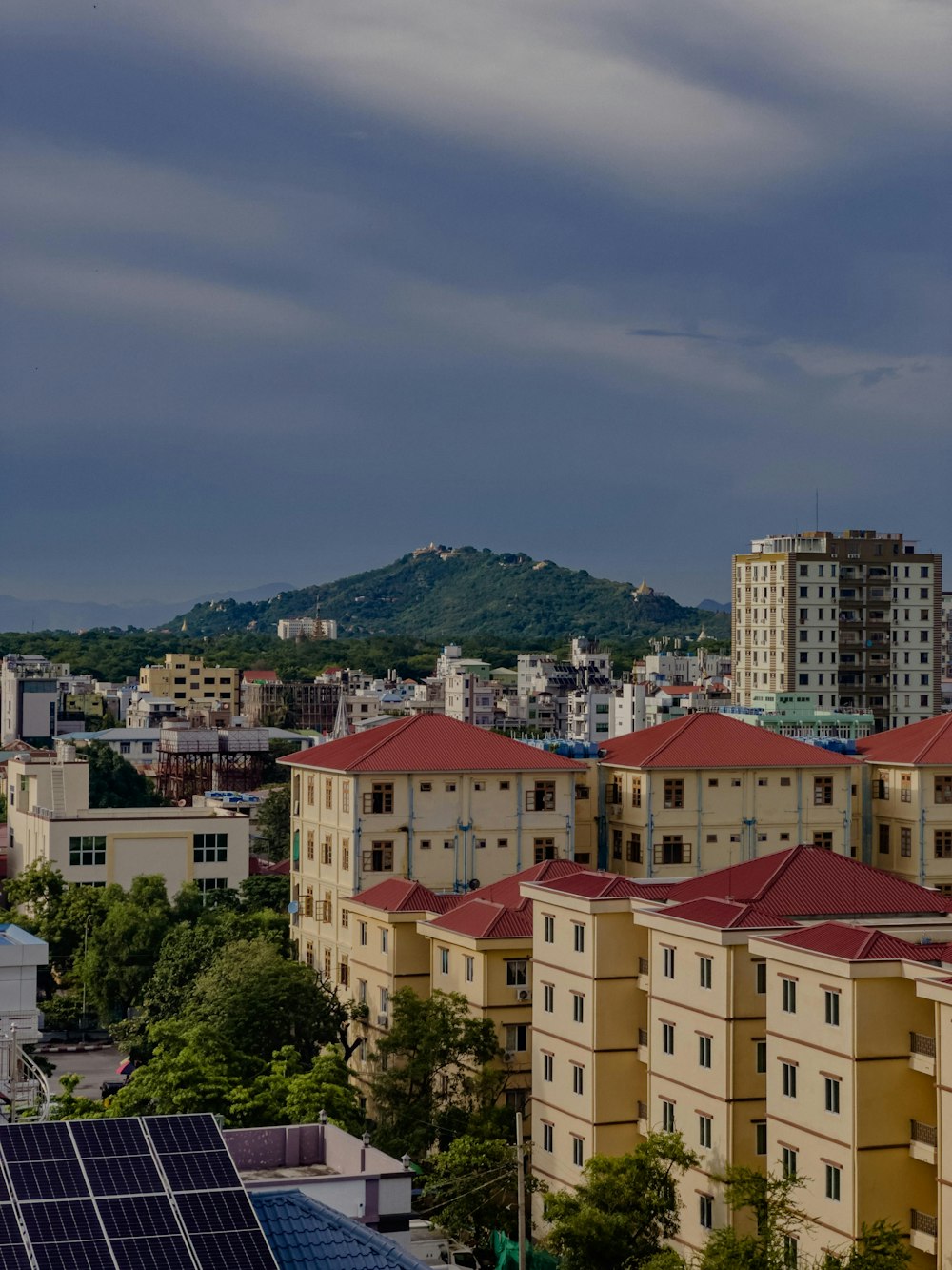 a view of a city with buildings and mountains in the background