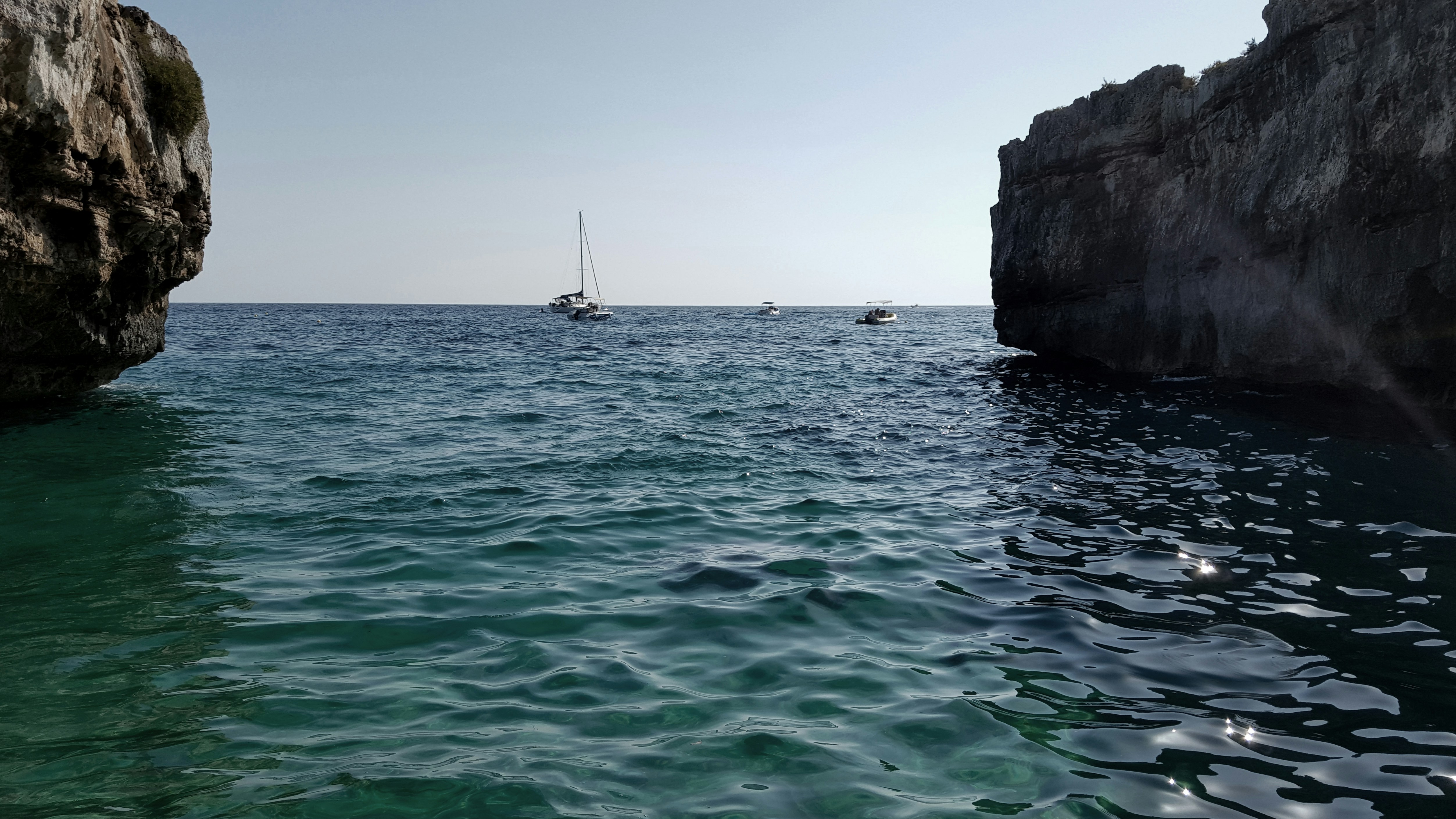 a couple of boats are out in the water, Sunset in Puglia, Italy, Day off in the beautiful Mediterranean Sea.