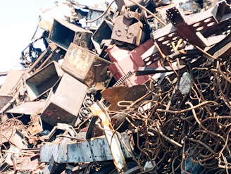 a pile of old televisions sitting on top of a pile of junk