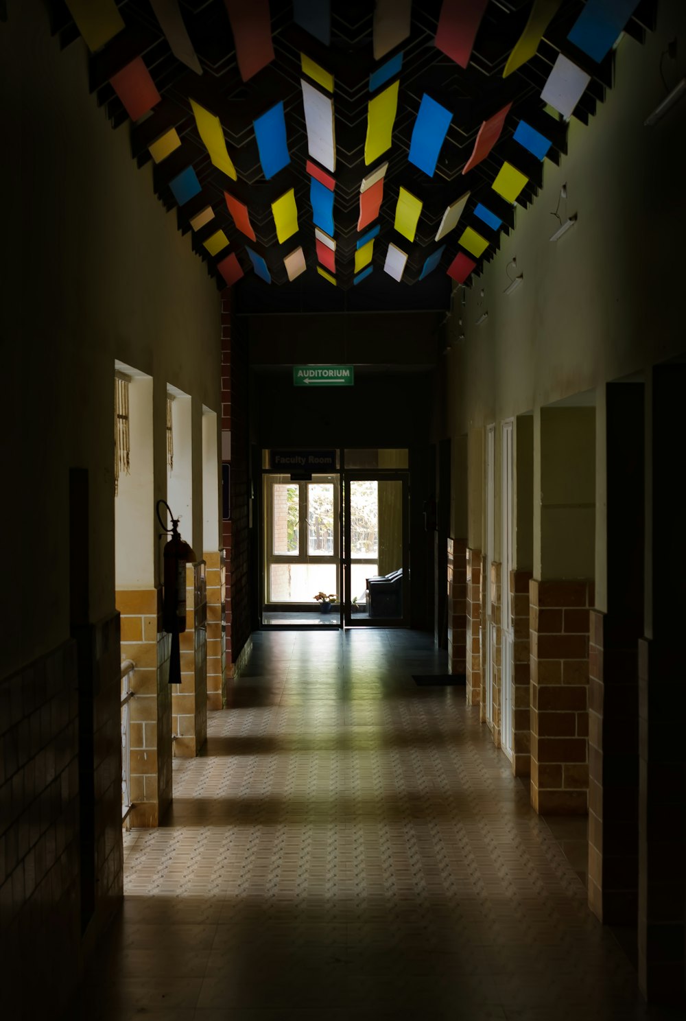 a long hallway with a ceiling made of multicolored squares