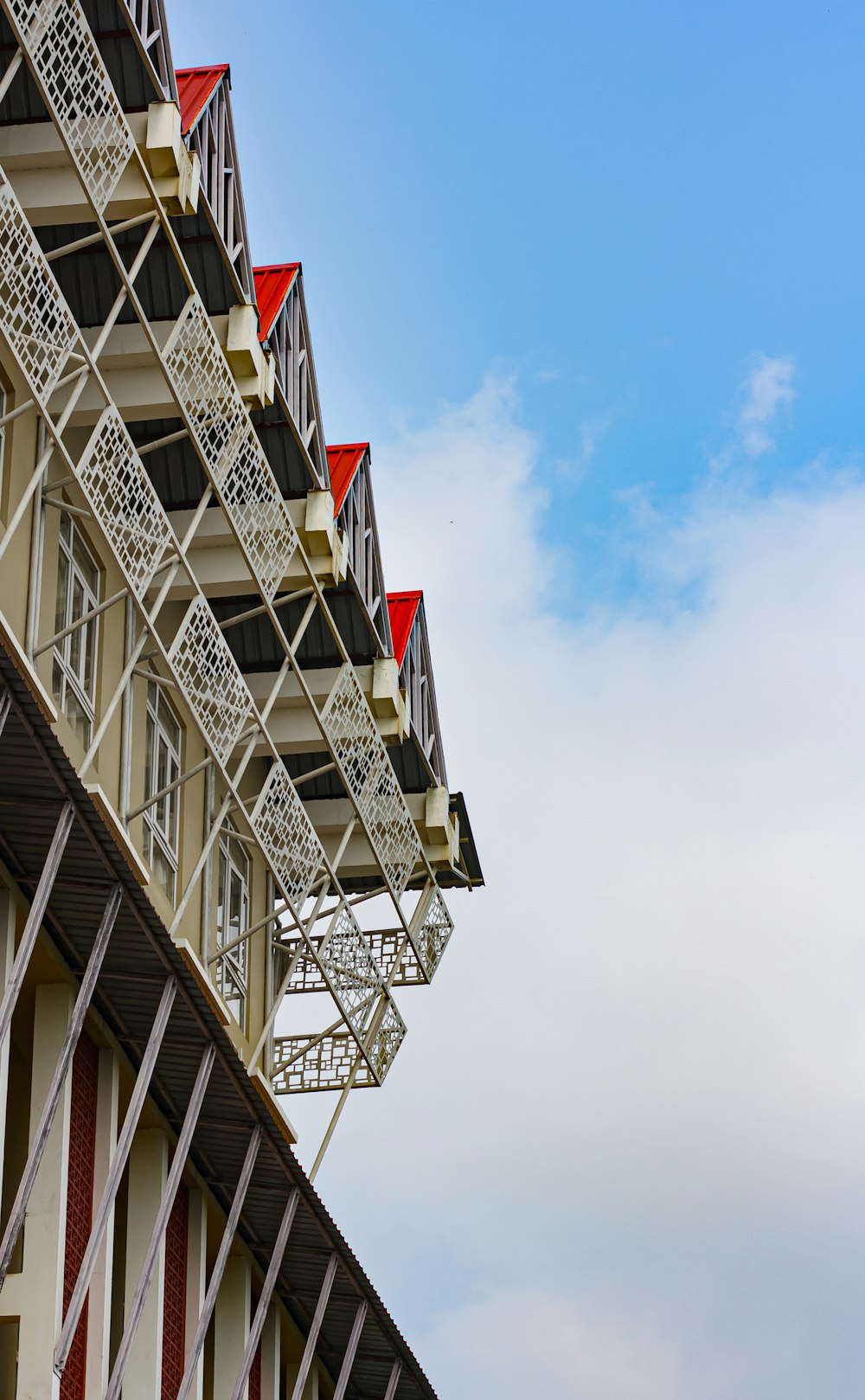 a tall building with red and white balconies