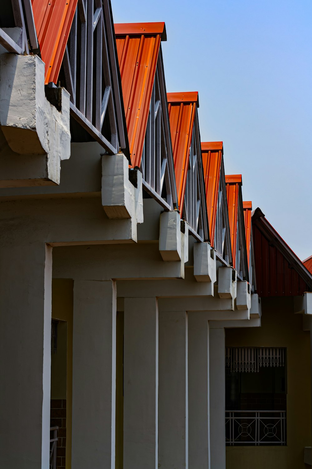 a row of orange roof tiles on a building