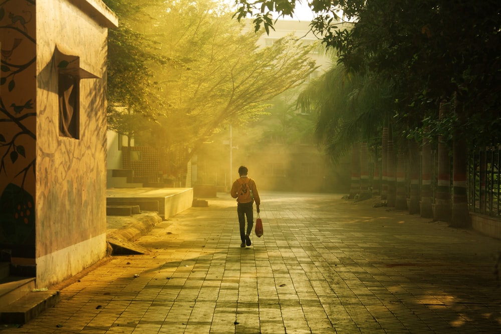 a man walking down a street holding a bag