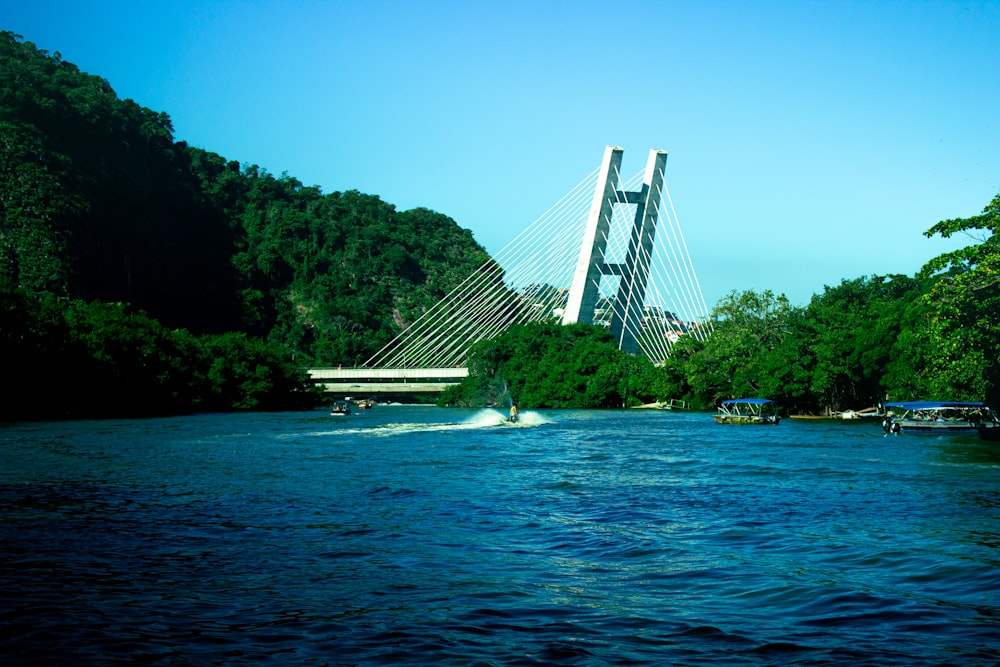 a boat traveling down a river next to a bridge