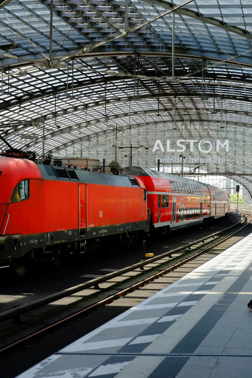 a red train pulling into a train station