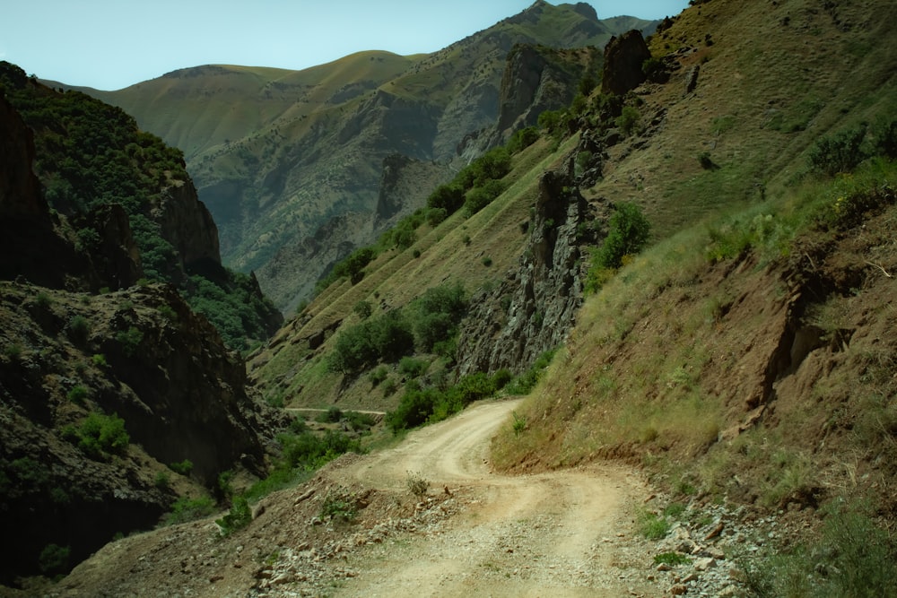 a dirt road in the middle of a mountainous area