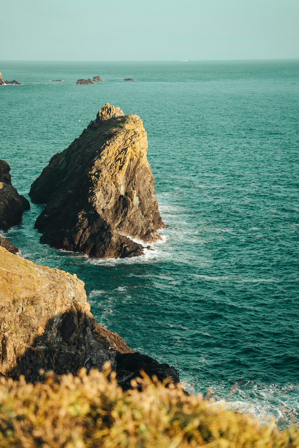 a large body of water sitting next to a rocky shore