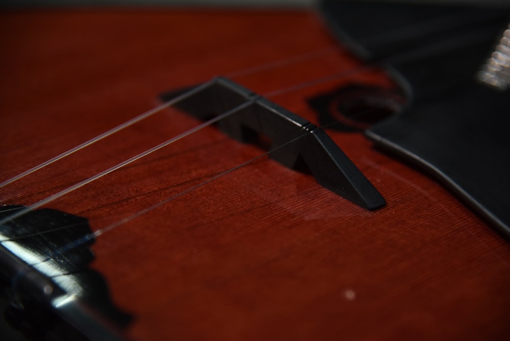 a close up of a guitar's neck and bridge