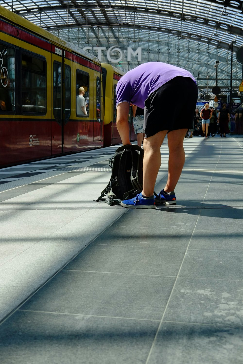 a person bending over with a bag on the ground