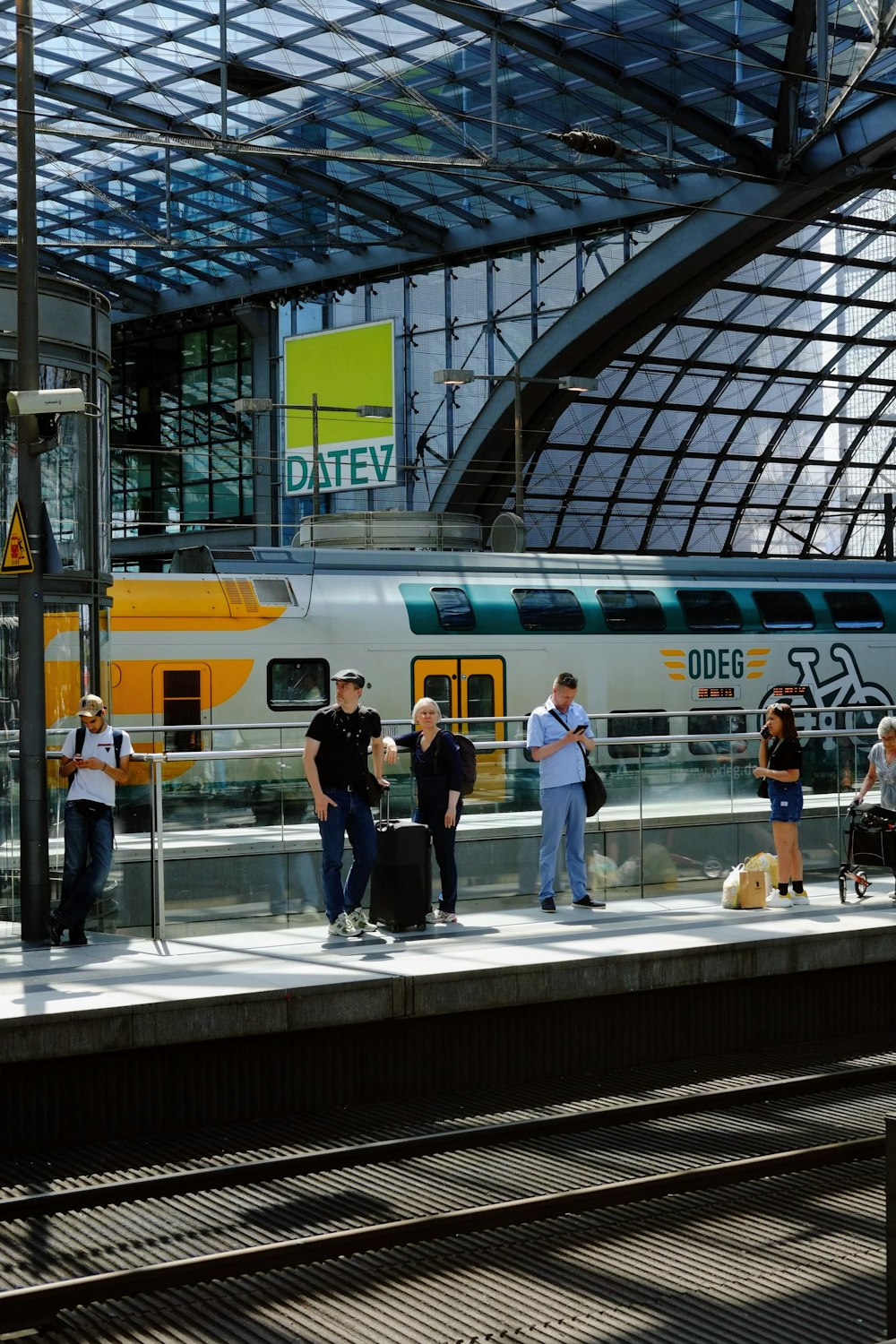 a group of people standing on a platform next to a train