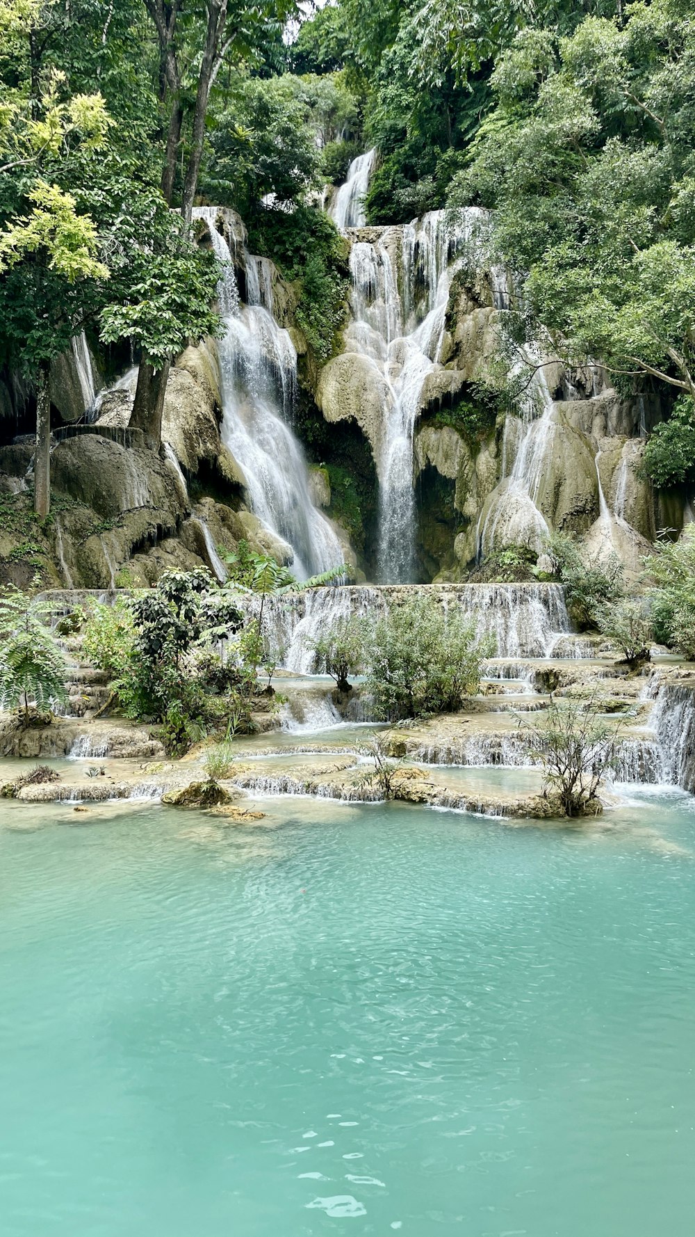 a waterfall in the middle of a body of water