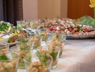 A colorful spread of appetizers on a white tablecloth.