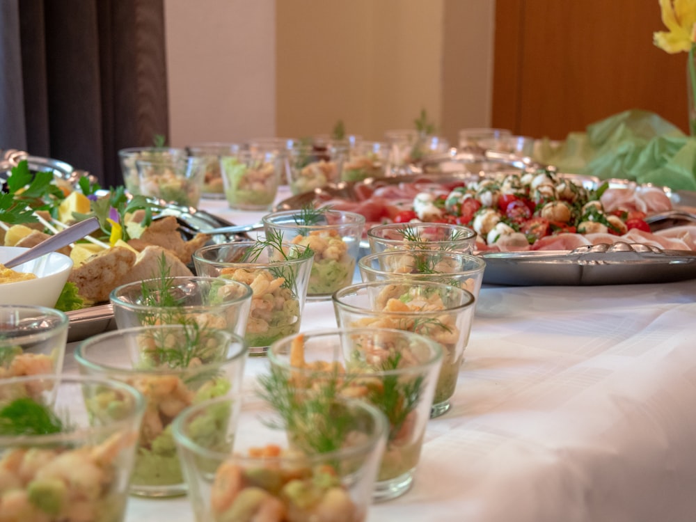 a table full of food and glasses of water