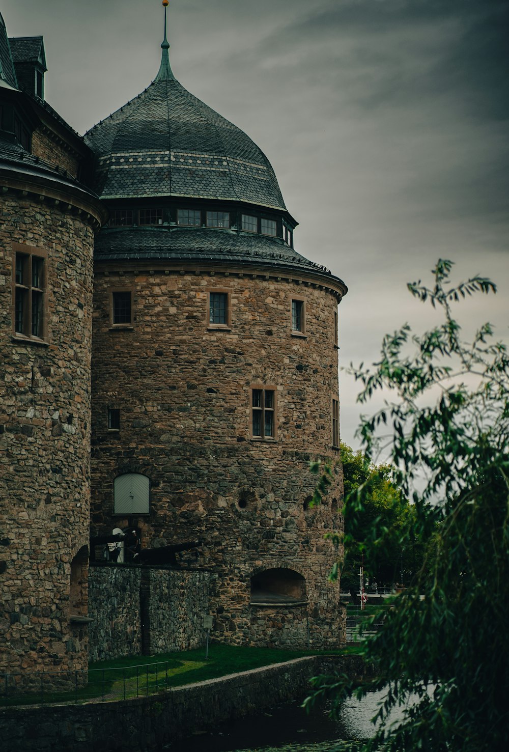 a tall brick building with a clock on the top of it