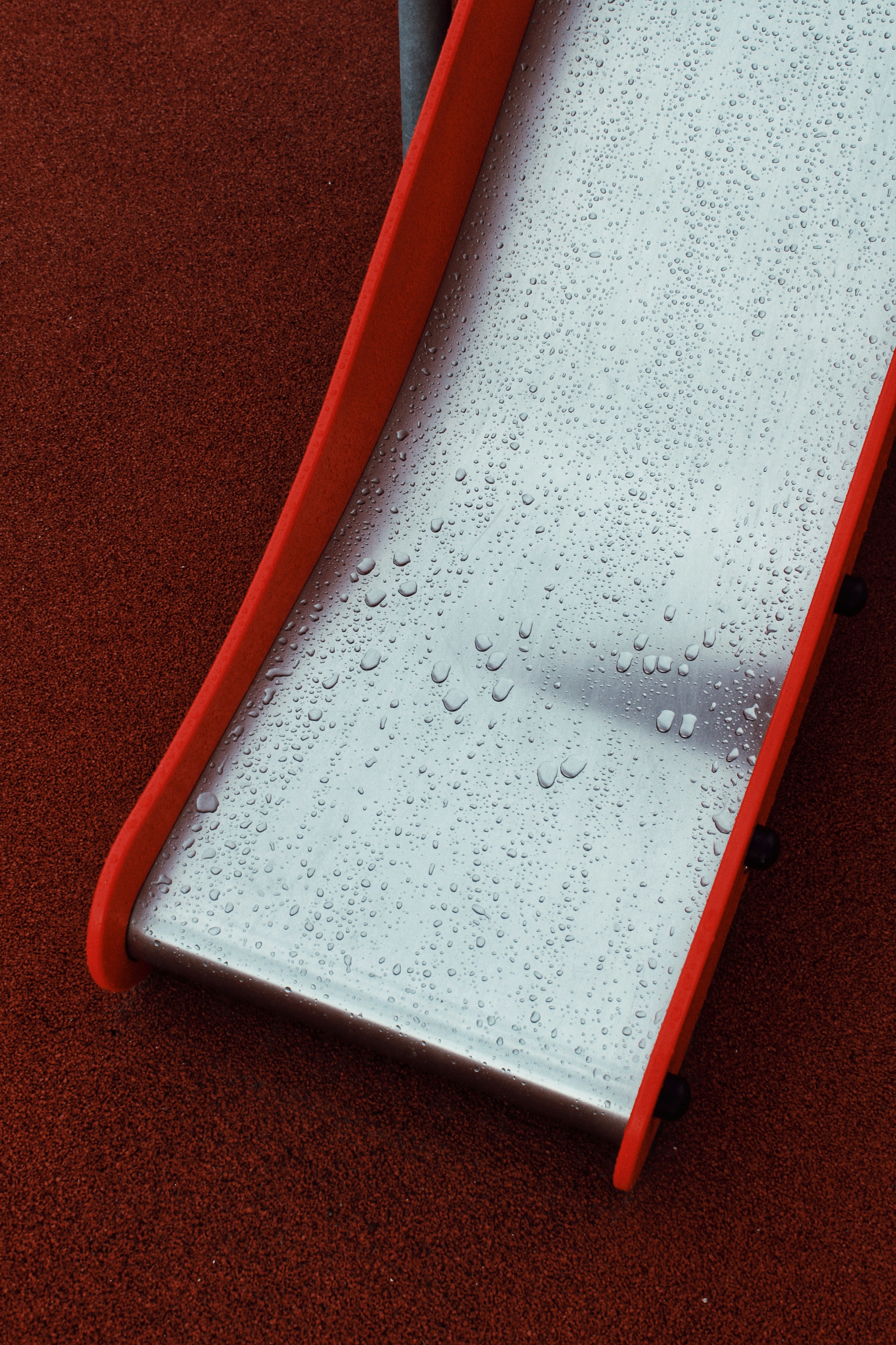 a close up of a water slide on a red surface