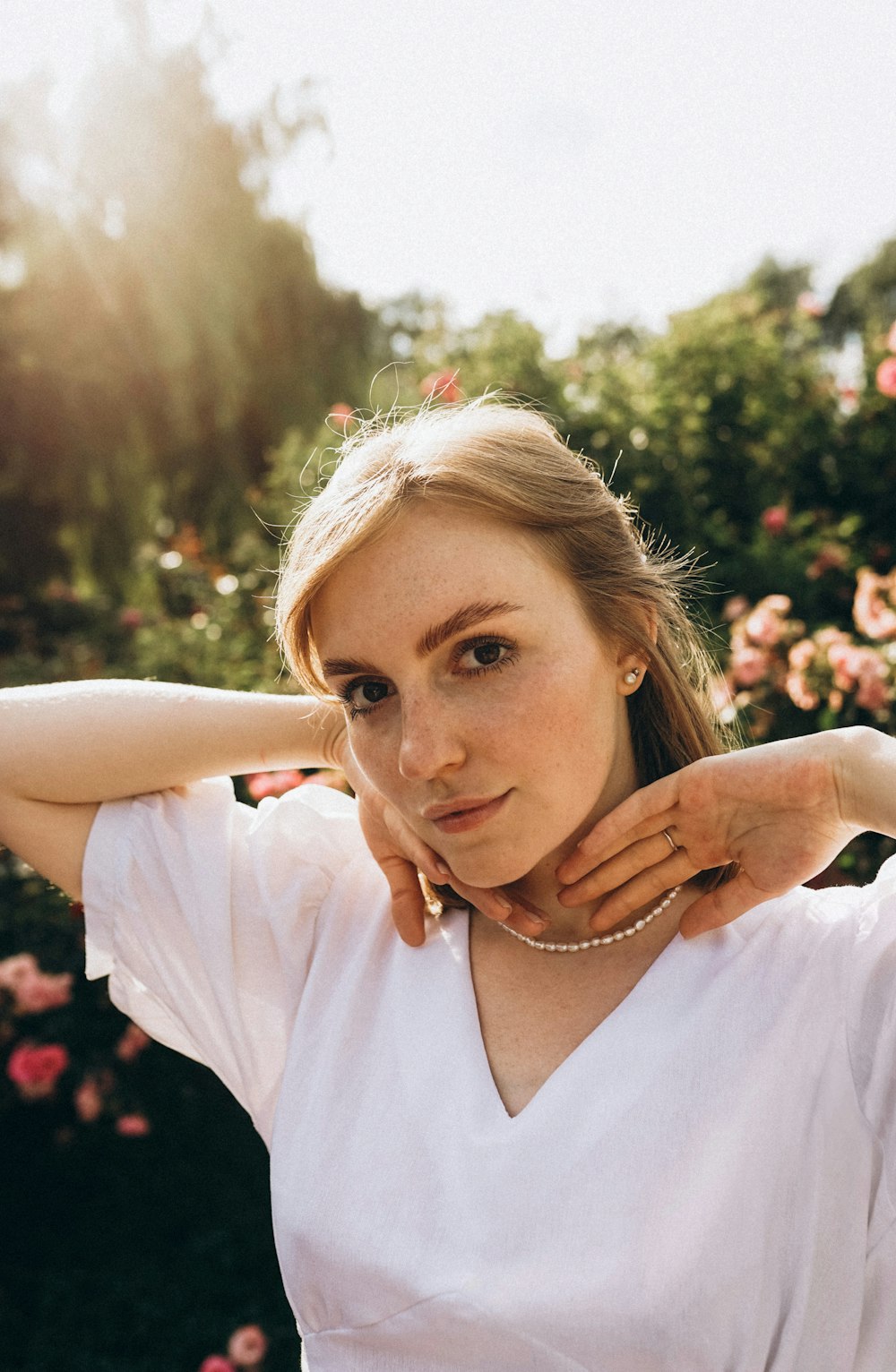 a woman in a white shirt posing for a picture