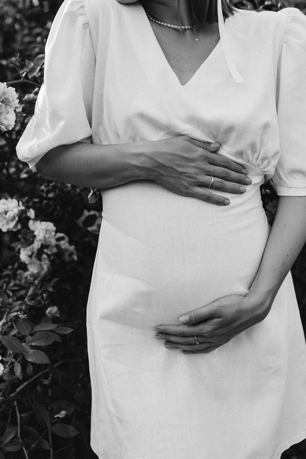 a black and white photo of a pregnant woman